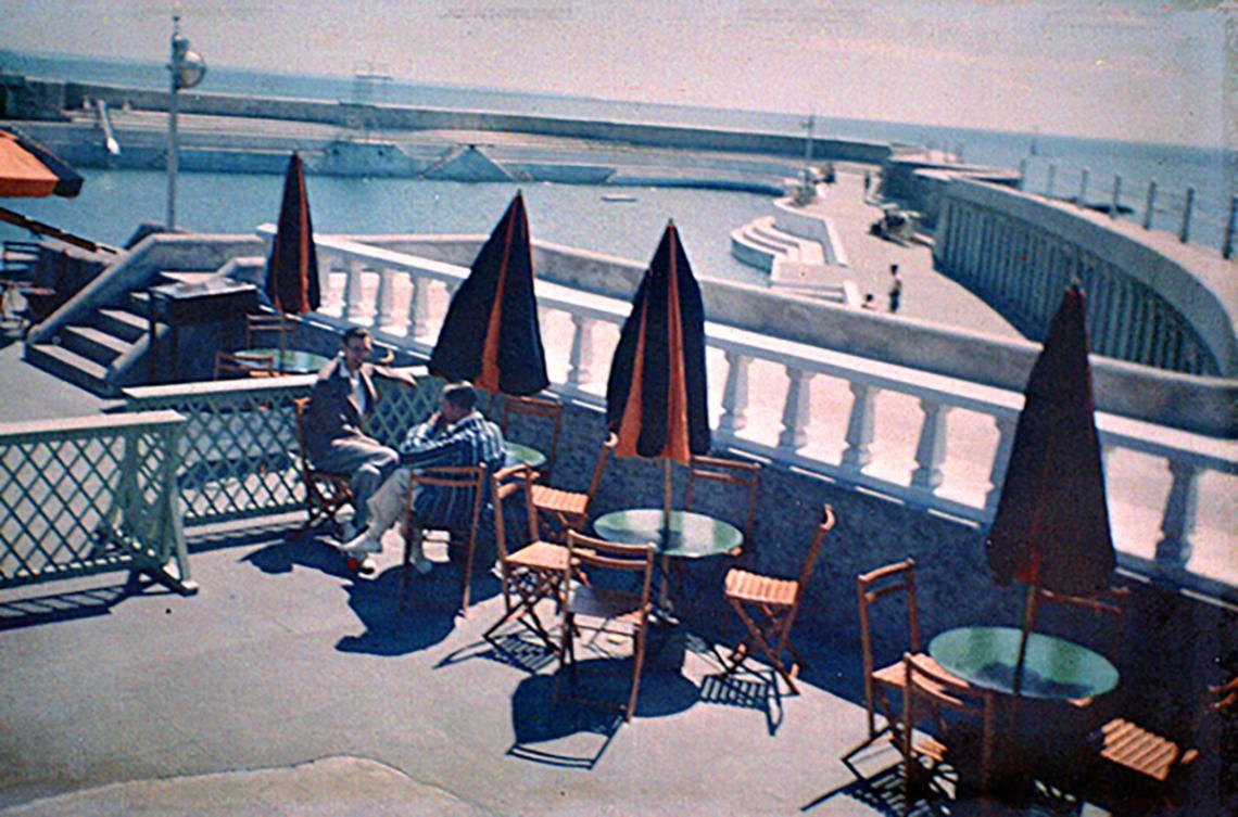 Men on café terrace and Jubilee Pool